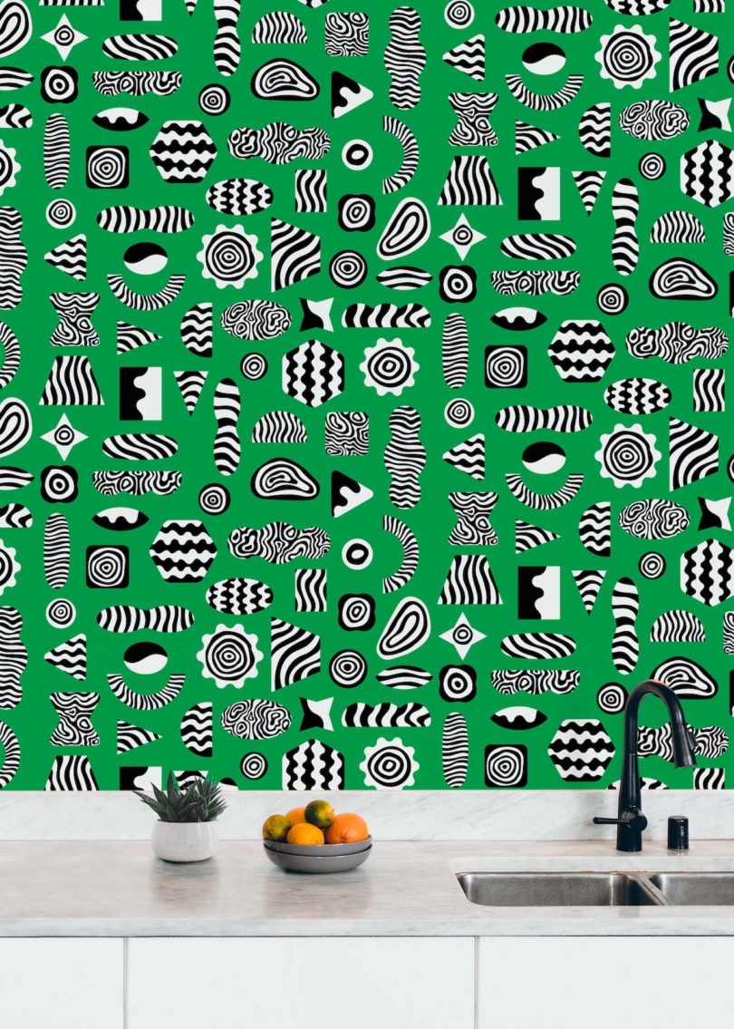 green black and white wallpaper next to a sink
