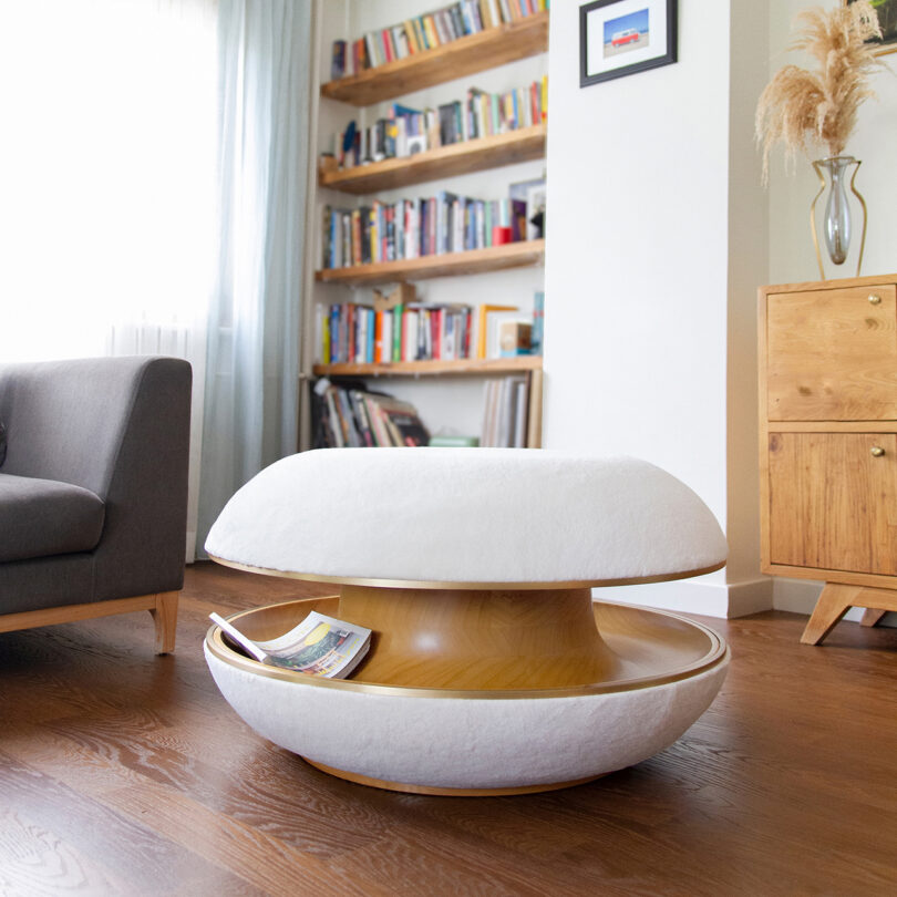 white and wood donut-shaped pouf in a styled interior space