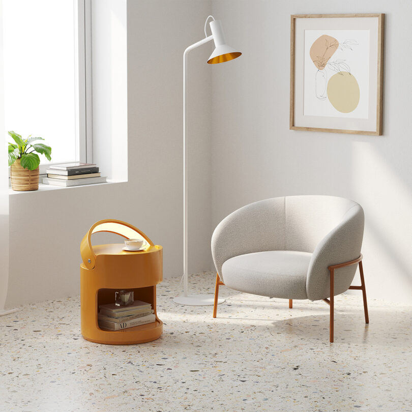 white armchair and dark yellow side table with light in styled interior space