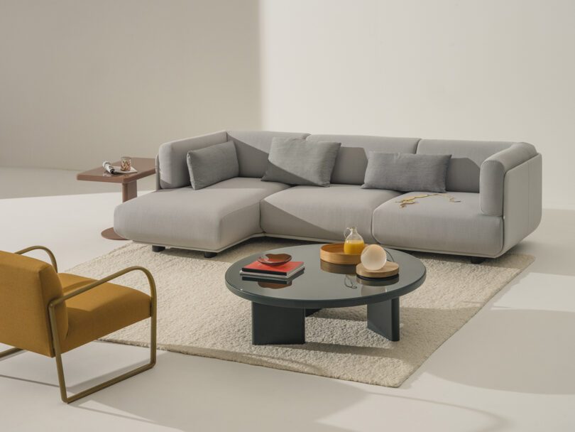 styled round coffee table with sofa and armchair