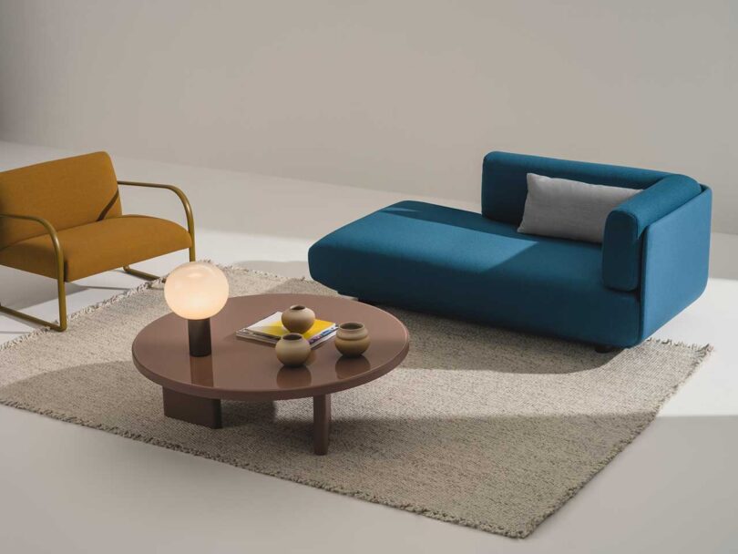 styled round coffee table with sofa and armchair