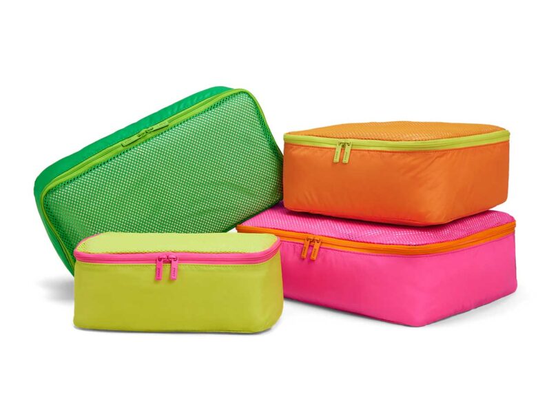 set of four semi-stacked neon packing cubes