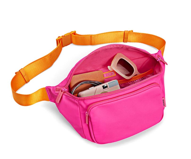 waist bag in neon pink and orange with open zipper revealing contents
