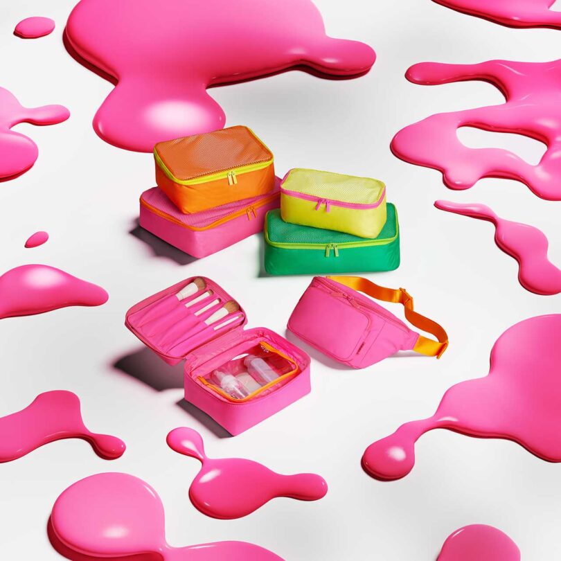 multiple neon packing cubes surrounded by pink neon blobs