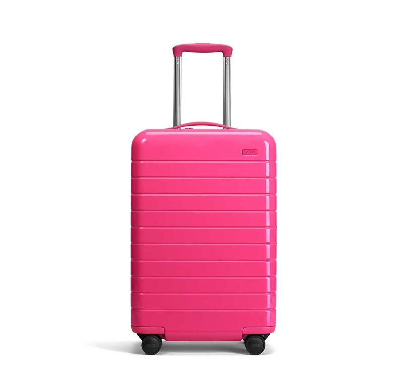 front of neon pink carryon suitcase
