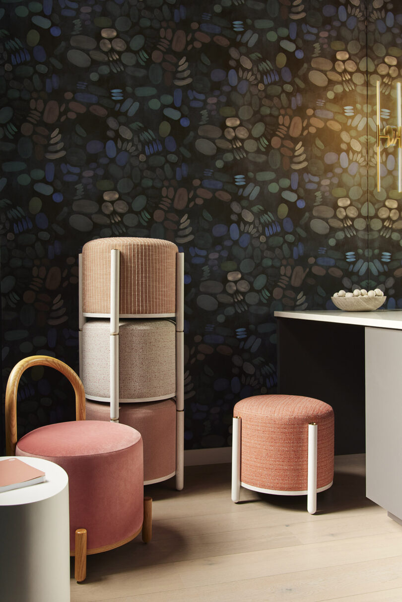 three warm toned pouf stools and four more stacked in the background