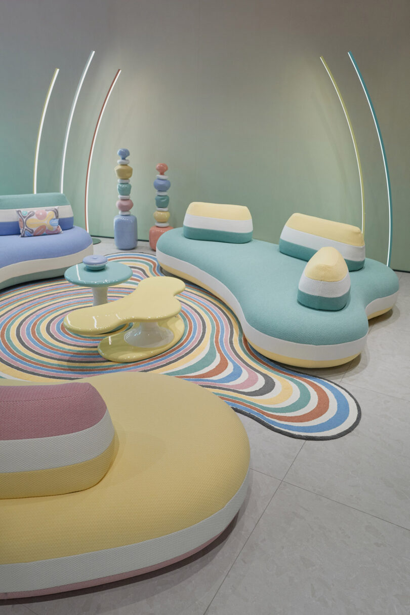showroom displaying pastel colored organically shaped pouf seating, tables, and rugs