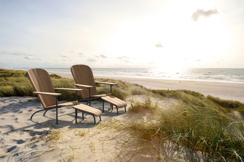 two modern wood adirondack chairs on the beach