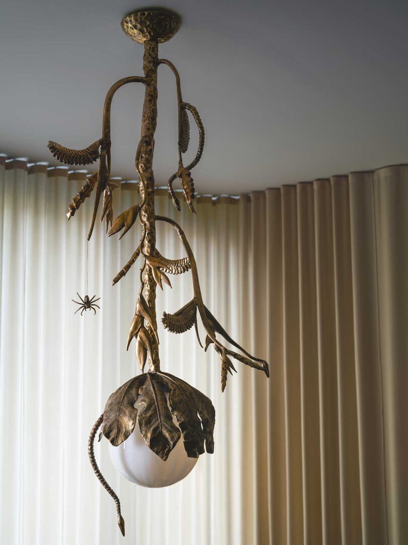 closeup of brass flower sculpture hanging from ceiling
