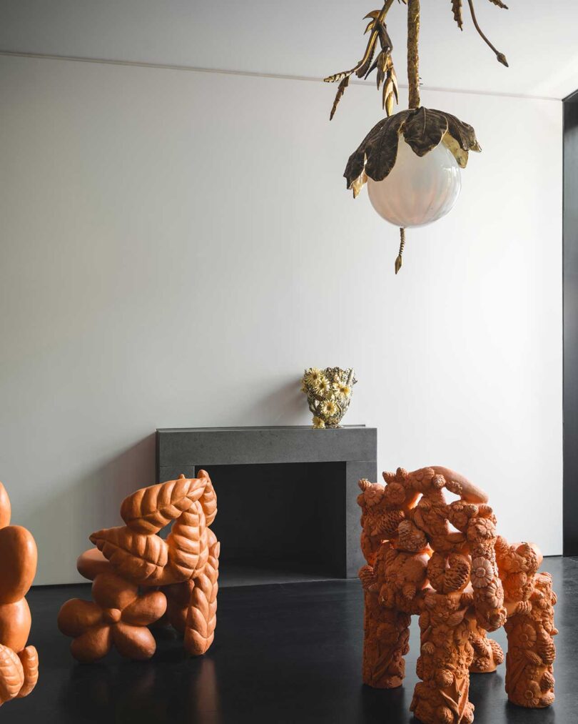 interior space with large terracotta flower themed furniture pieces on display