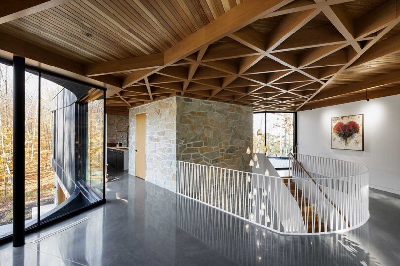 interior view of modern home with unique curved staircase and patterned wood ceiling