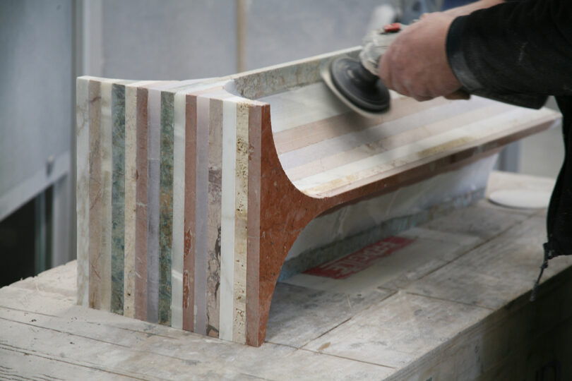 production of furniture made from different colors of marble for a striped effect