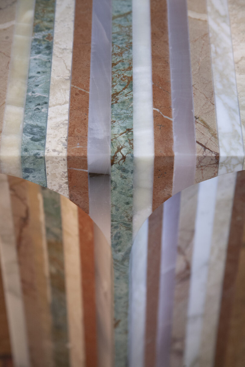 detail of side table made from different colors of marble for a striped effect
