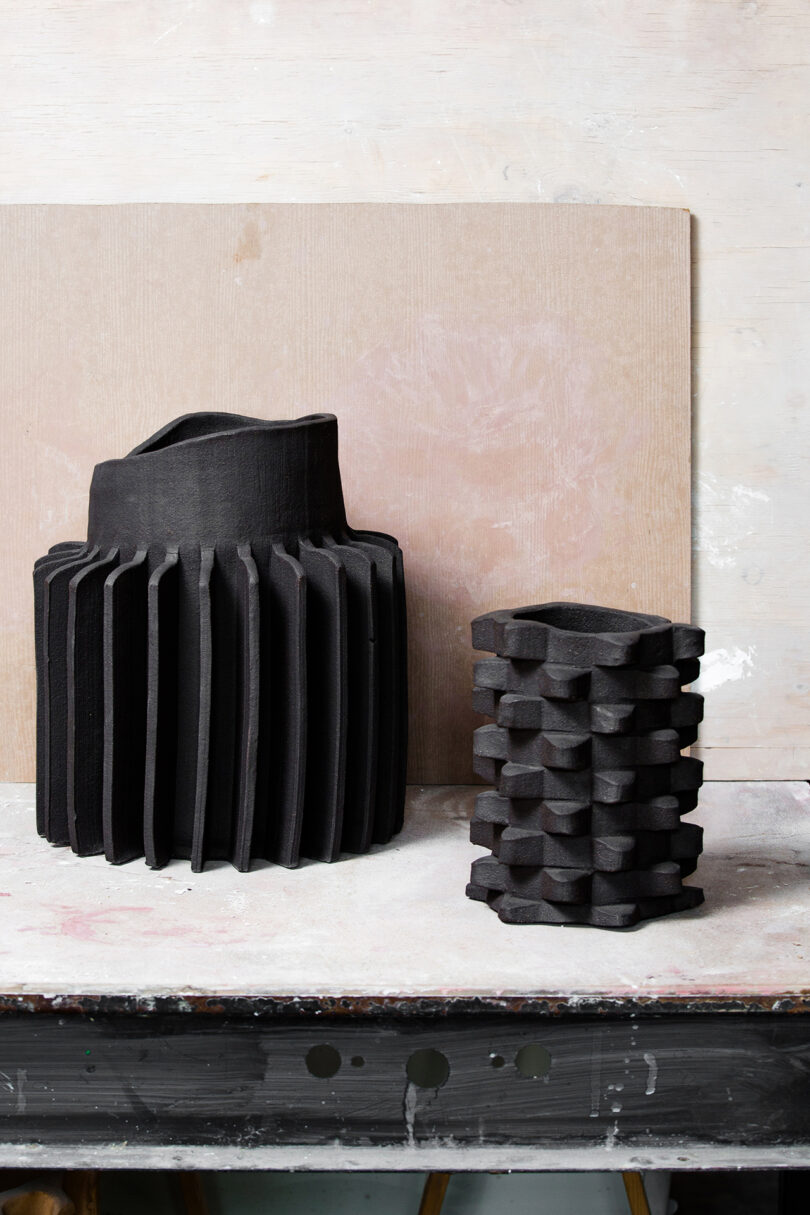 two sculptural black vases