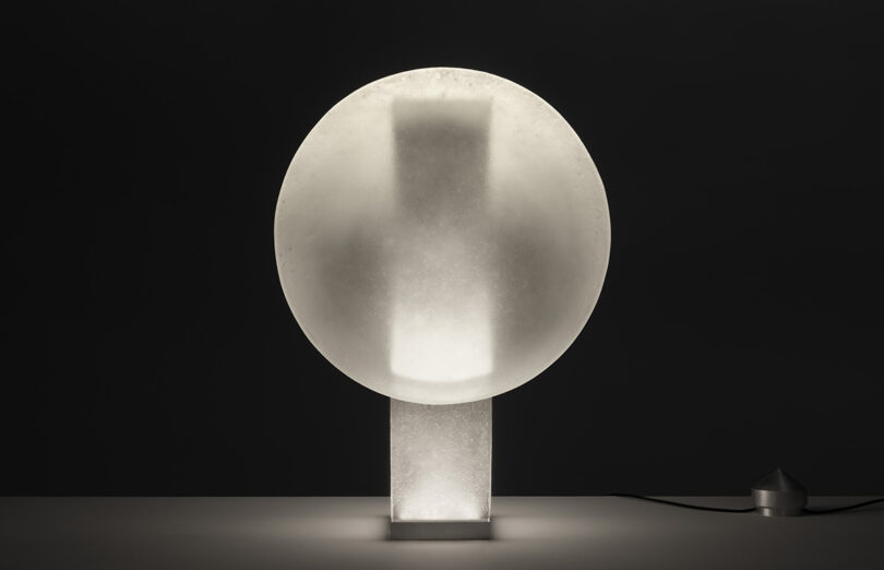Front view of Vestige light glowing softly in a darkened room.