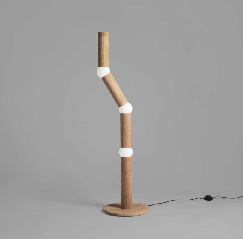 slender floor lamp with four segments, each connected by a round lightbulb