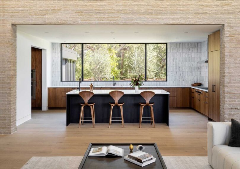 interior view into modern minimalist kitchen with black island