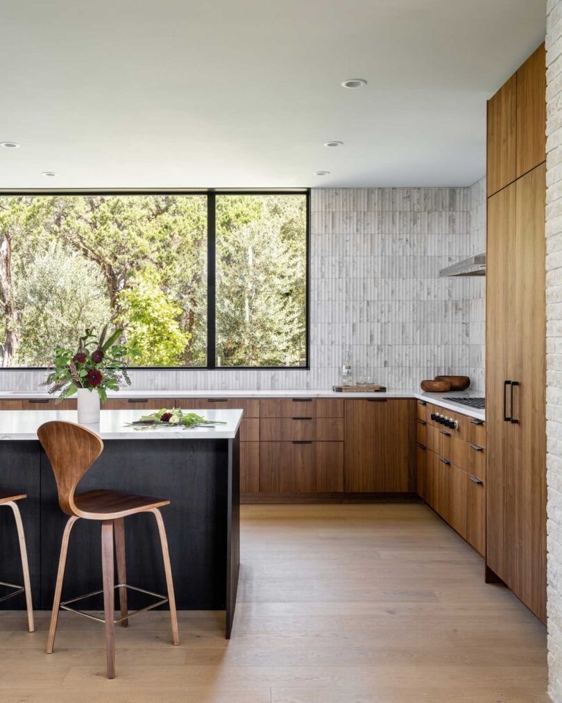 interior view into modern minimalist kitchen with black island