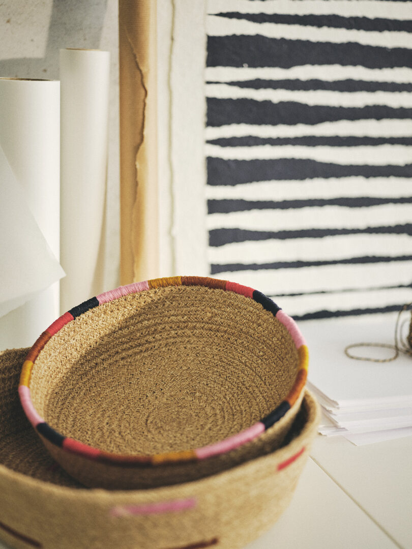 two stacked woven baskets with colorful edging