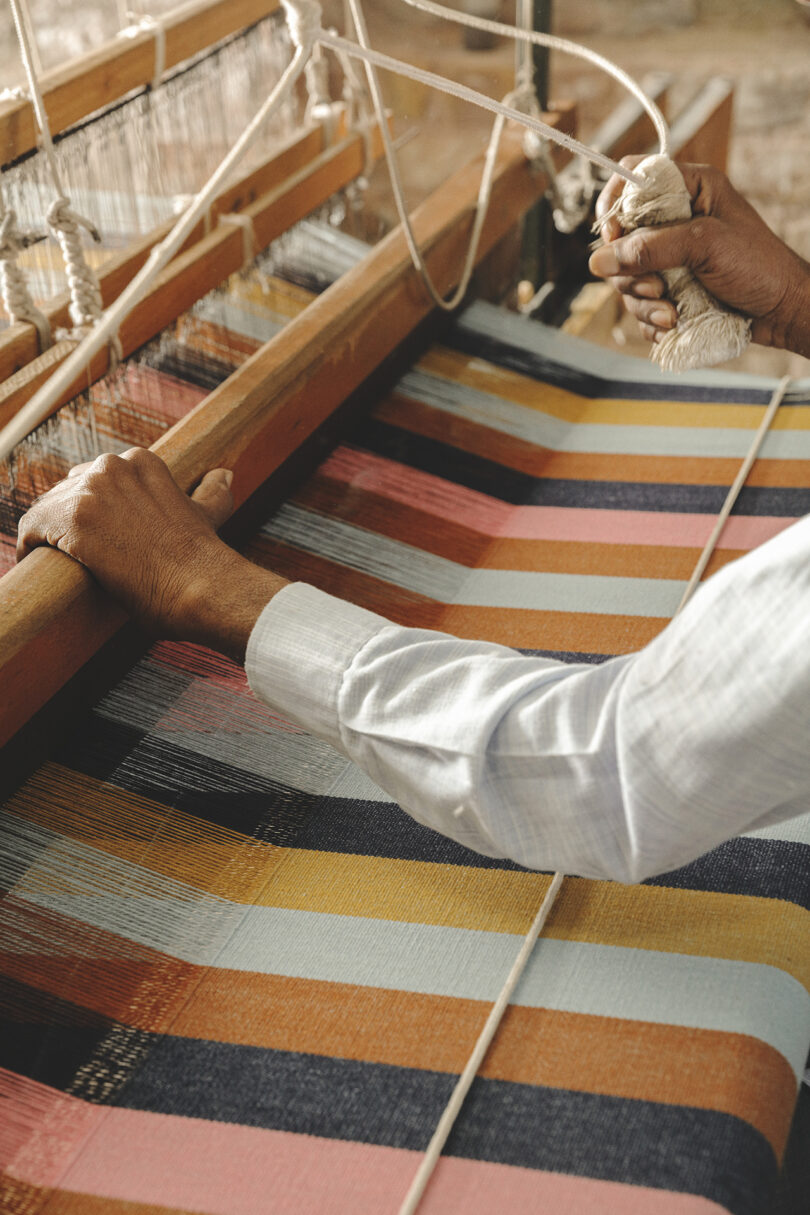 colorful striped rug on a loom