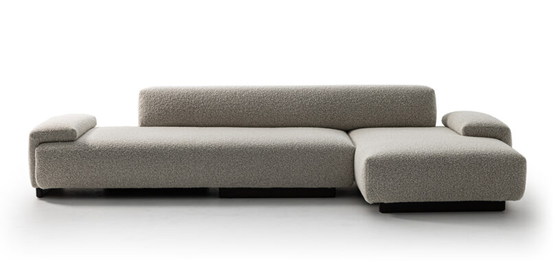 dark grey L-shaped sofa on white background