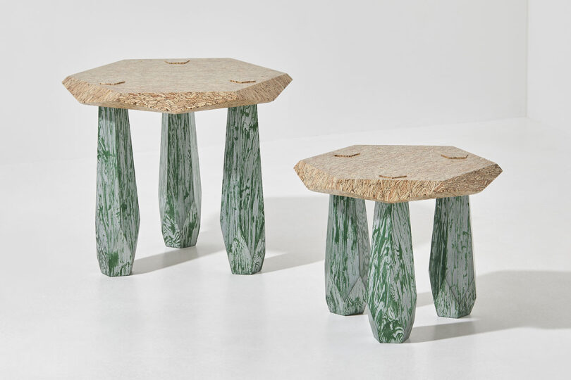 two differently sized three legged structures with light wood tops and green legs
