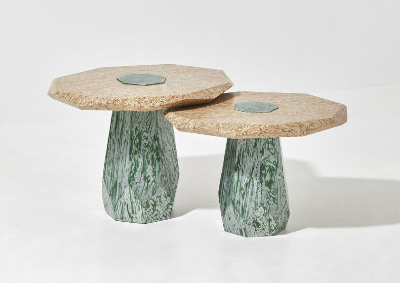 two differently sized structures with light wood tops and green legs