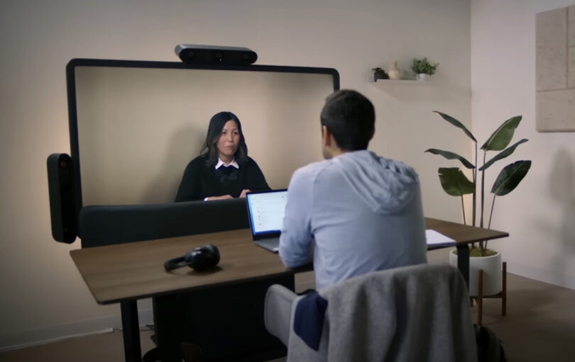 Man and woman video conferencing from home office setting.