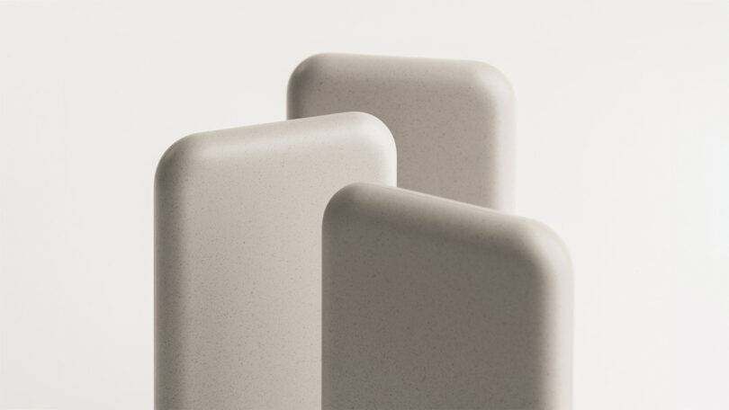 Three neutral hued Samsung x Layer Battery Packs from back view.