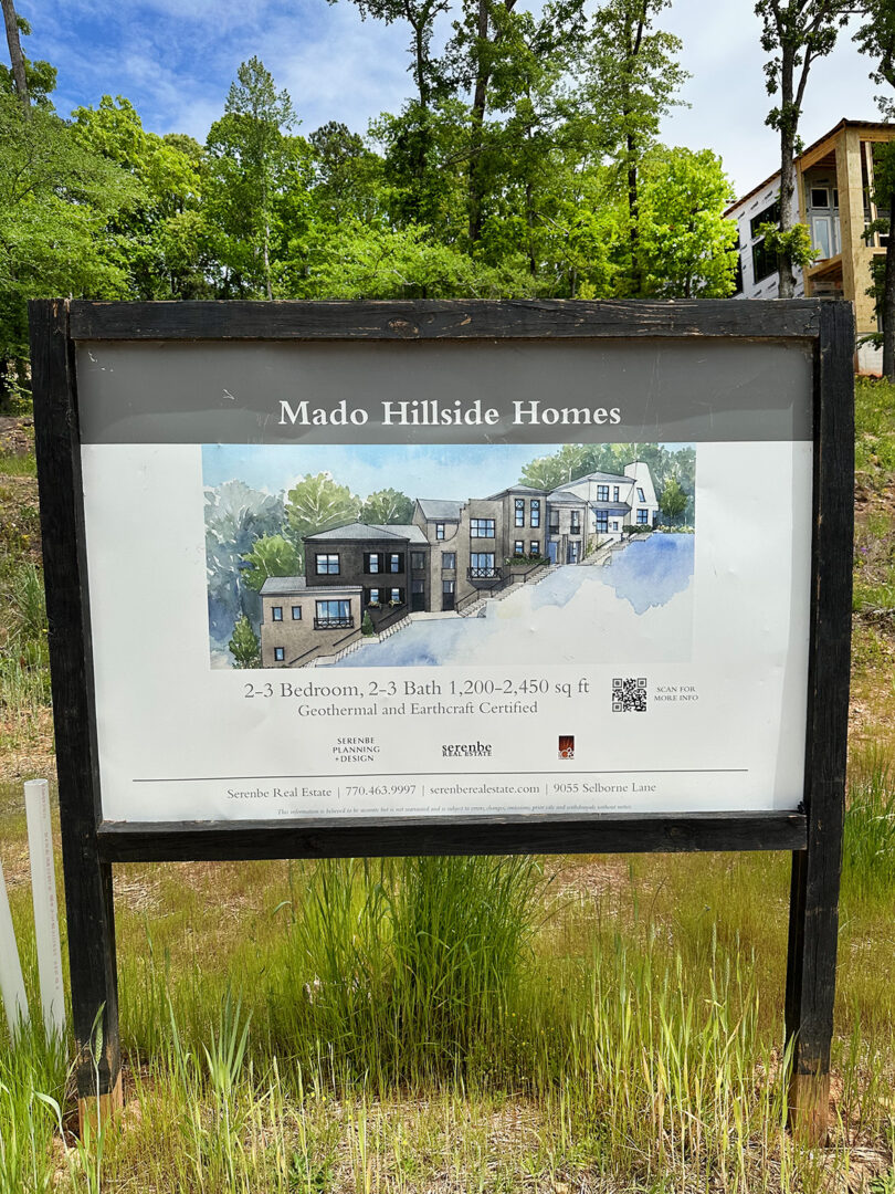 Sign showing future development, with pricing and square footage.