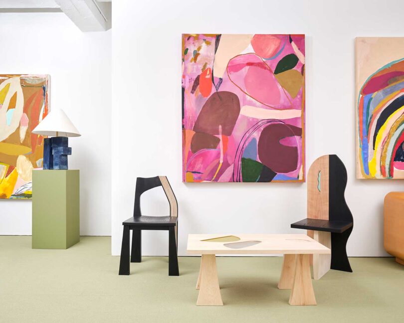 exhibition vignette with colorful abstract art and modern chairs