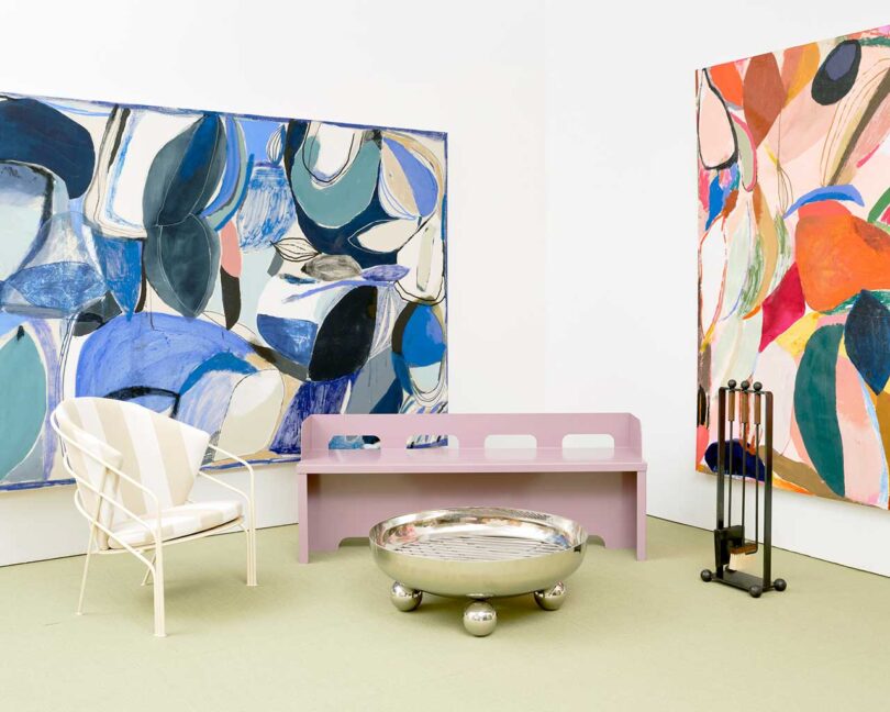 exhibition vignette with colorful abstract art and modern chairs