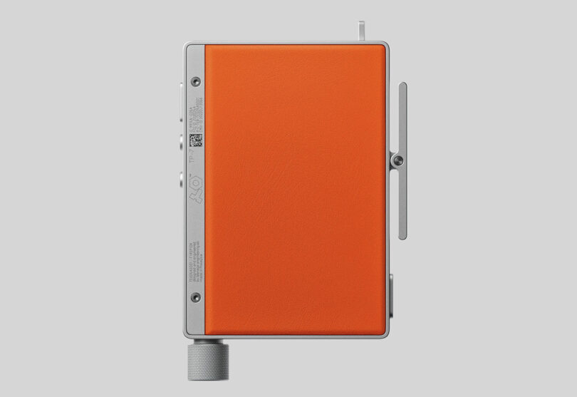 Back view of Teenage Engineering TP-7 field recorder with bright orange cover