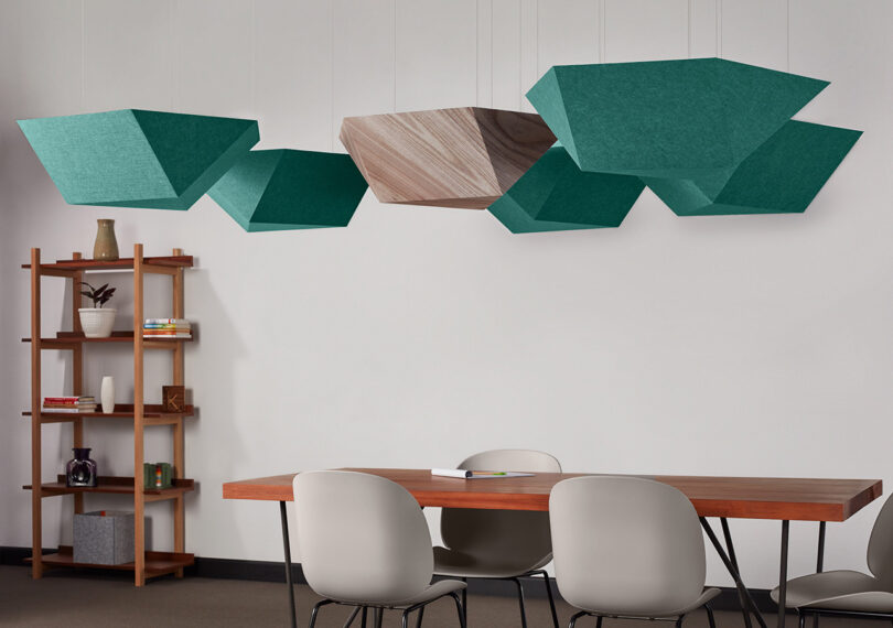 group of turquoise and beige polygon-shaped acoustic pendants in a styled space