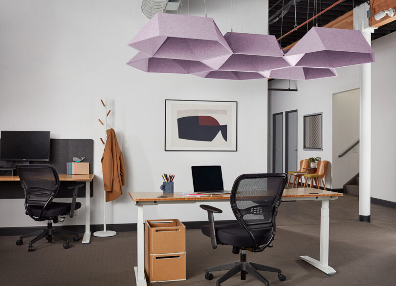 group of lavender polygon-shaped acoustic pendants in a styled space