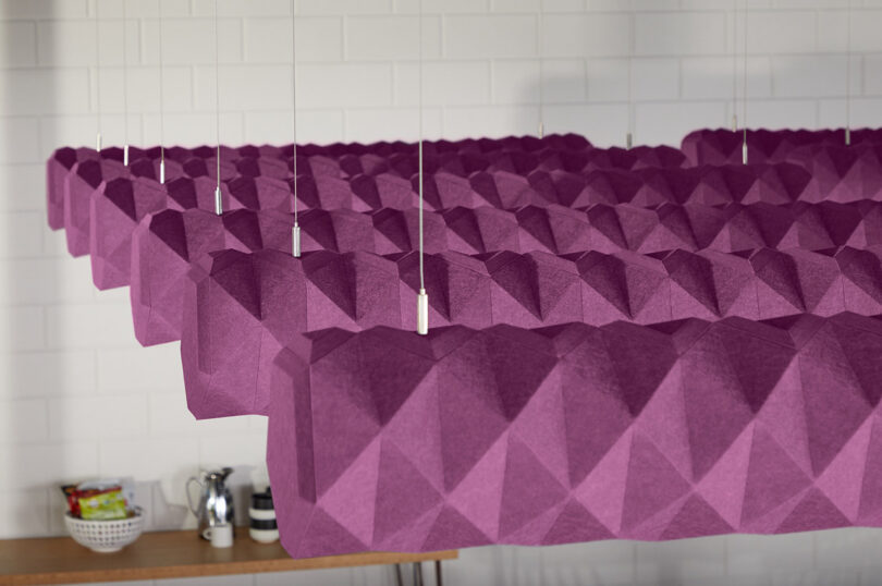purple acoustic baffles hanging in a styled space