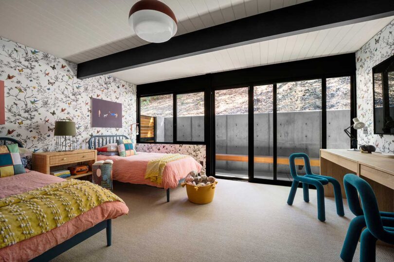 angled interior view of mid-century modern bedroom with twin beds