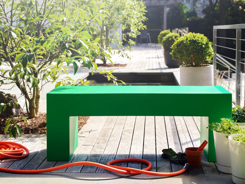 minimal modern green outdoor bench on a deck