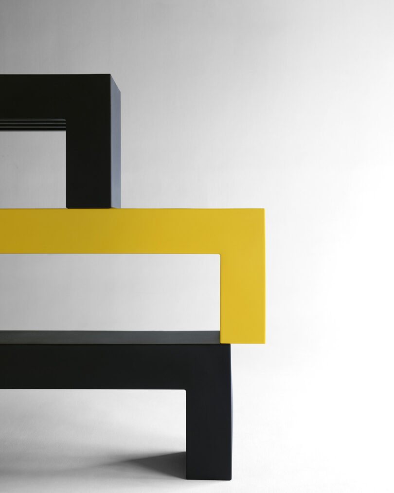 three stacked minimal modern black and yellow outdoor benches