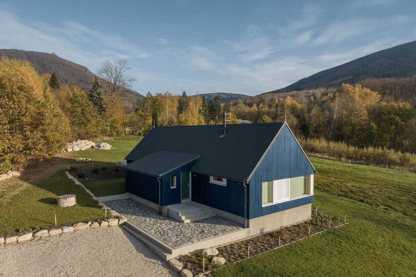 elevated corner exterior of modern blue cabin
