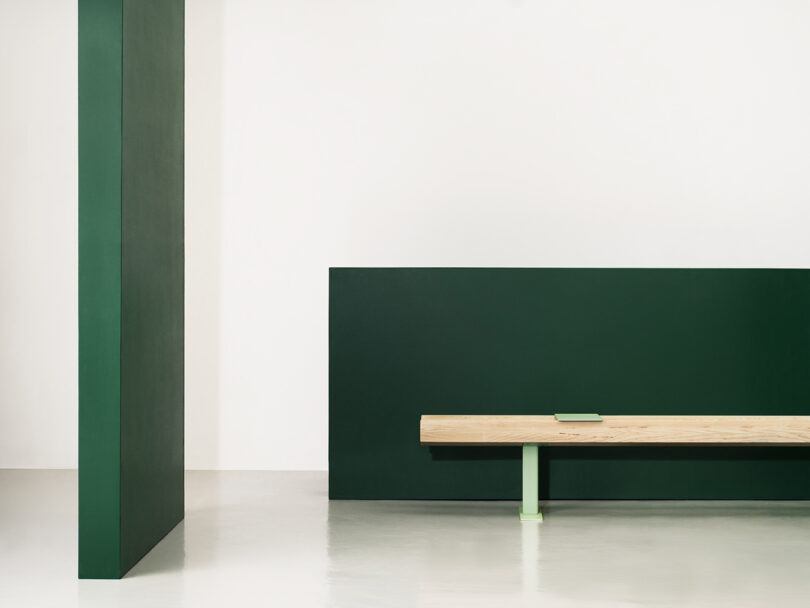 light wood bench with light green metal legs