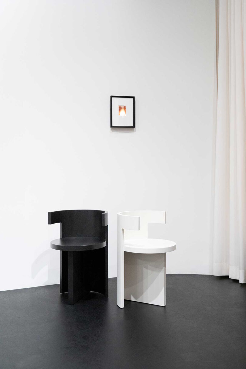 one black and one white sculptural chair