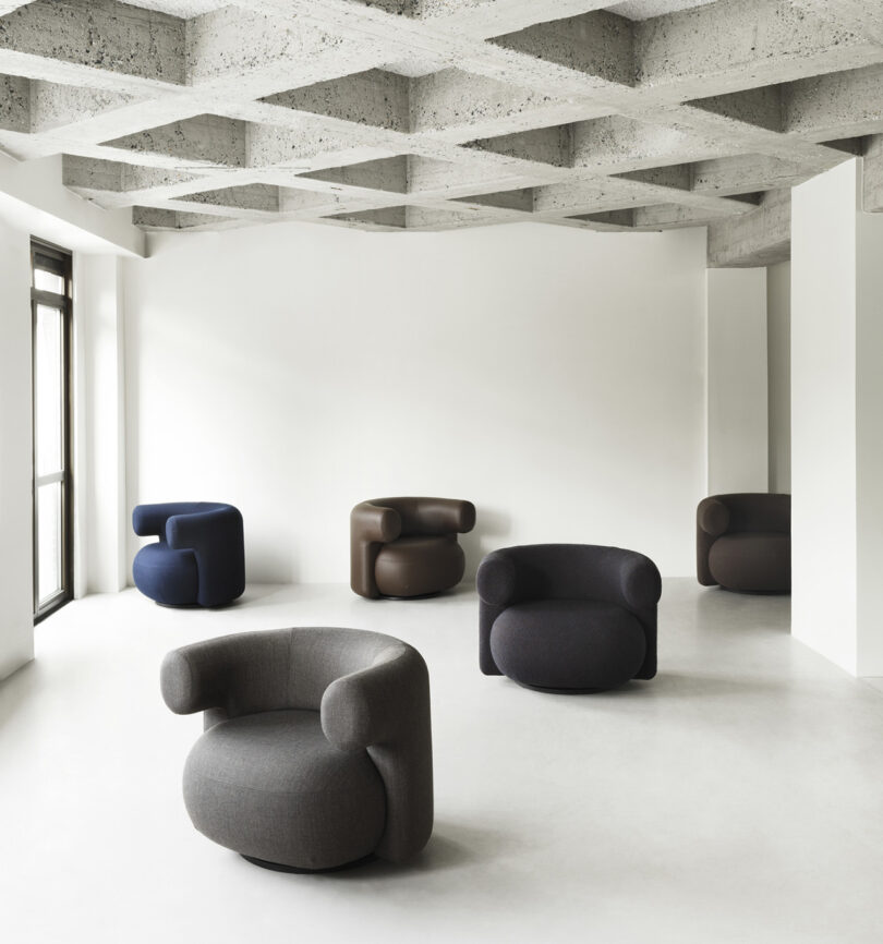 five modern armchairs in a studio space