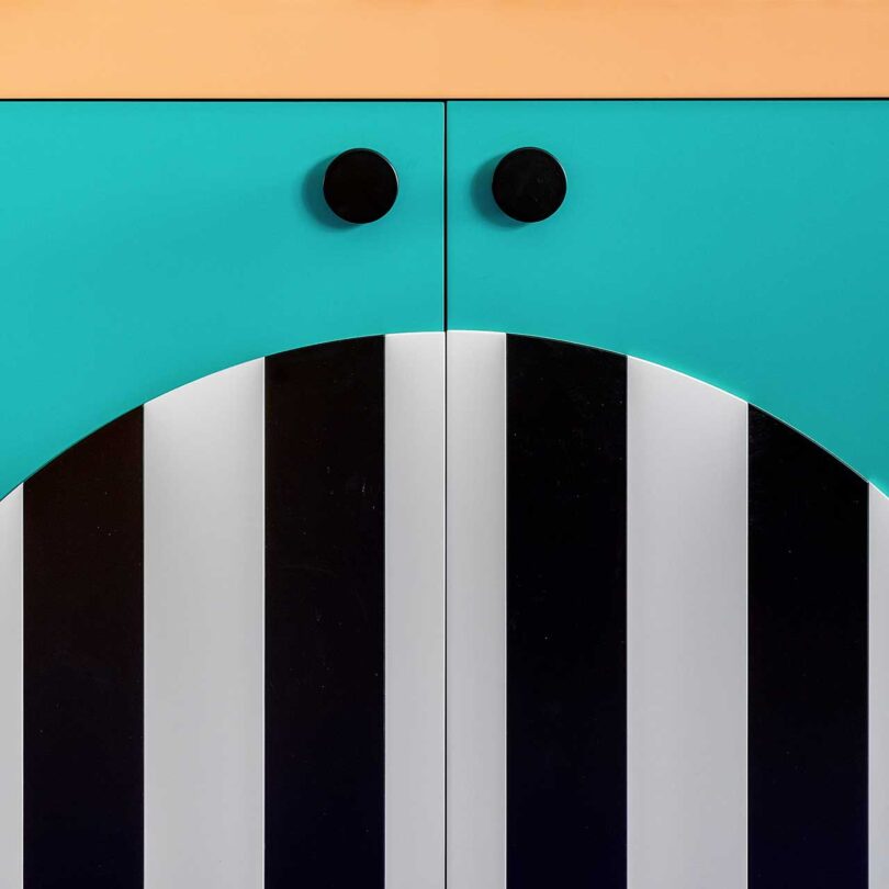closeup of colorful cabinets with black and white stripes and teal green