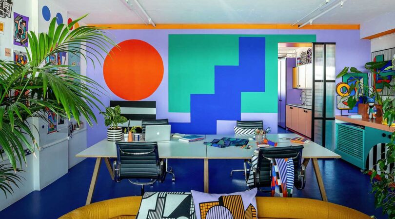 view of vibrant studio office with geometric artwork and mural