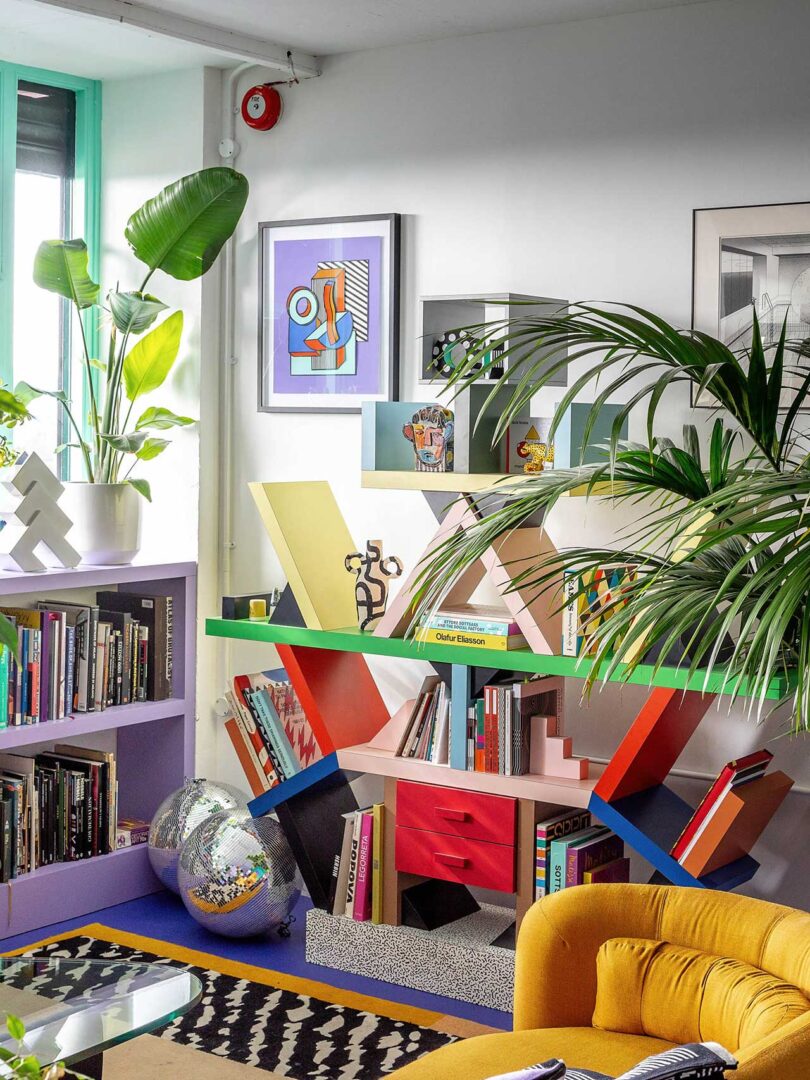 angled view of corner with memphis colorful shelf holding books and objects