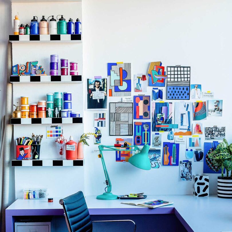 closeup of colorful office with small grouping of colorful art and shelves of paint