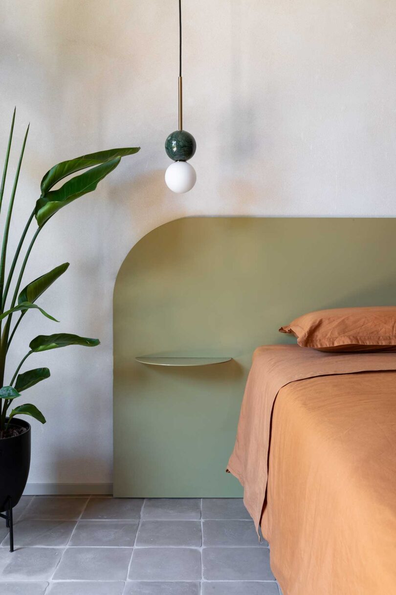 partial view of modern bed with peach and green bedding