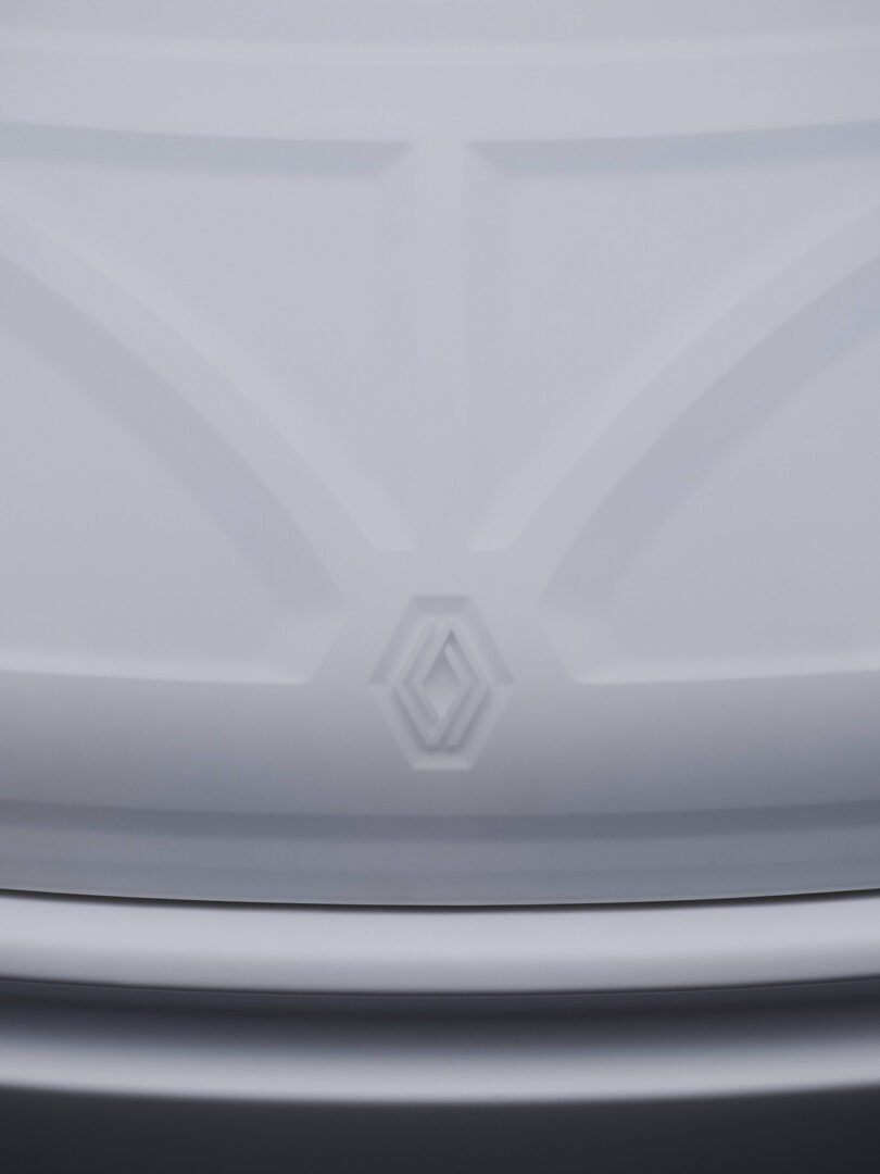 Detail of embossed Renault logo across Twingo's bonnet.