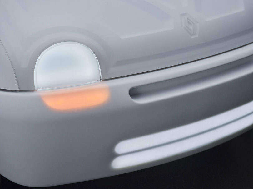 Detail of LED headlamp lights glowing from underneath the translucent white body paneling.